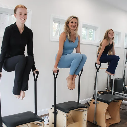 Pilates-Burlington-MA-Nicole-Burns-With-Clients-In-List